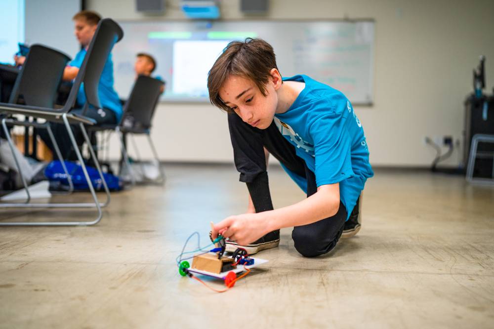 Student assembling robot car.